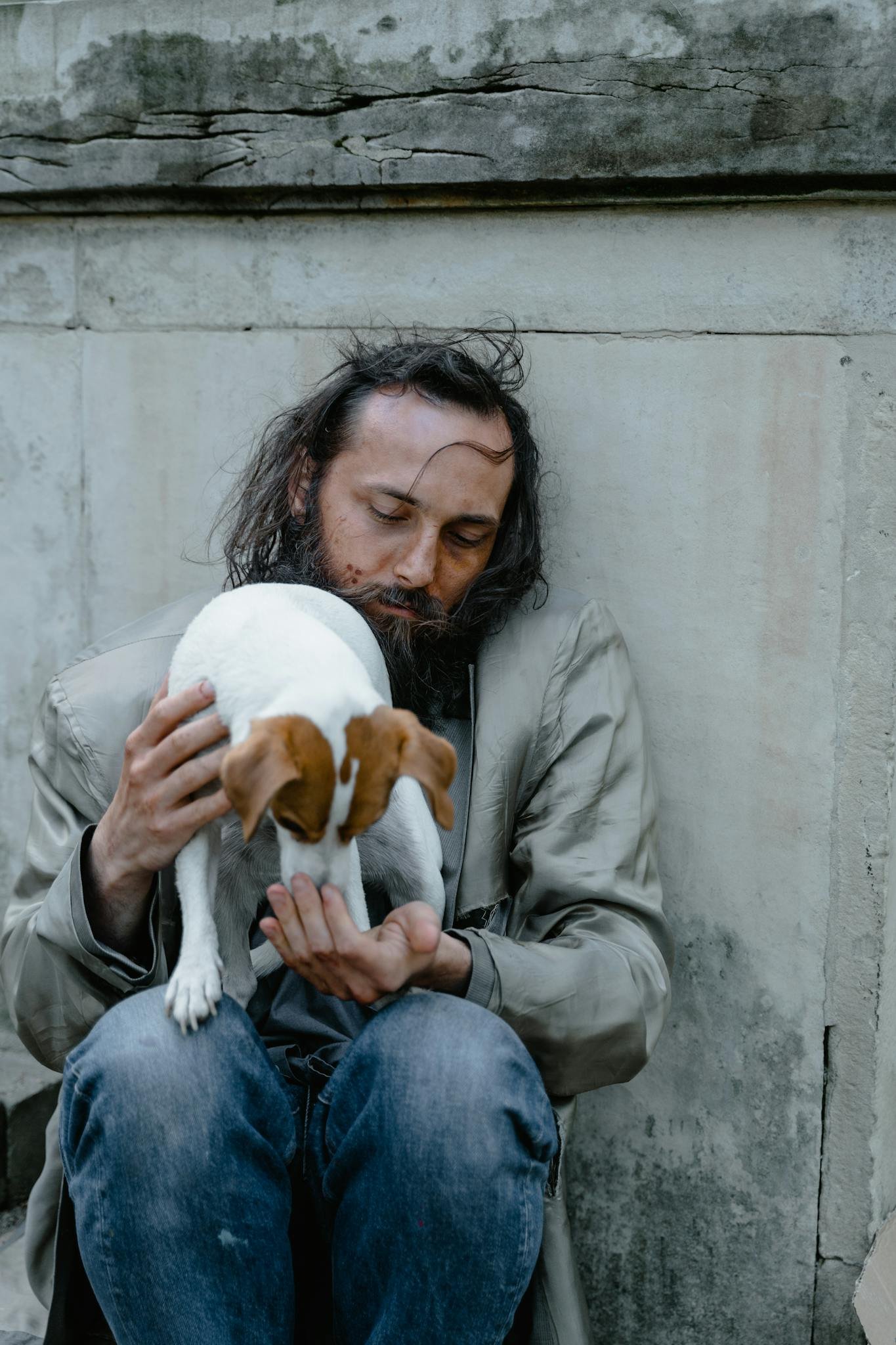 A compassionate scene of a homeless man feeding a small dog, showcasing kindness and companionship.